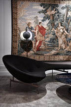 Decorative tapestry with classical scene in a room with modern black sculpture